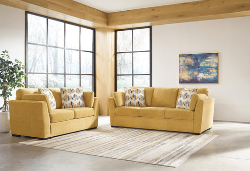 Ashley Furniture Keerwick living room set featuring a sofa, loveseat, and armchair with neutral upholstery and modern design.