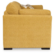 Ashley Furniture Keerwick sofa sleeper with beige upholstery, showing the side view of the convertible sleeper sofa in a modern living room setting.