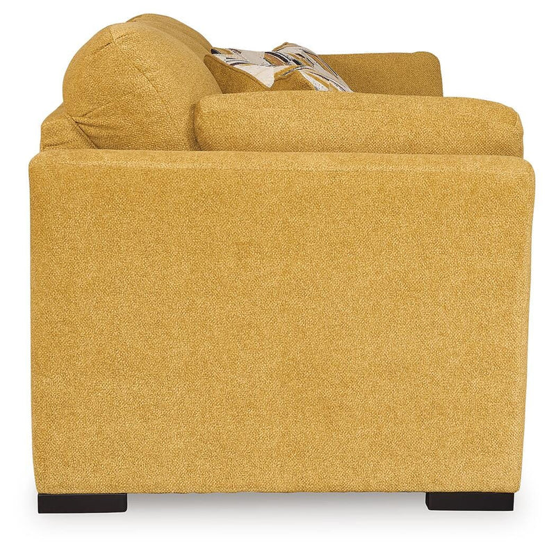Ashley Furniture Keerwick sofa sleeper with beige upholstery, showing the side view of the convertible sleeper sofa in a modern living room setting.