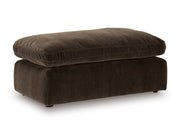 Ashley Furniture Maxton Heights Ottoman, stylish fabric ottoman with wooden legs, shown from an angled view.