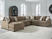 Ashley Furniture Camellia-Court sectional with chaise, beige fabric, modern design, and plush cushions in a living room setting.
