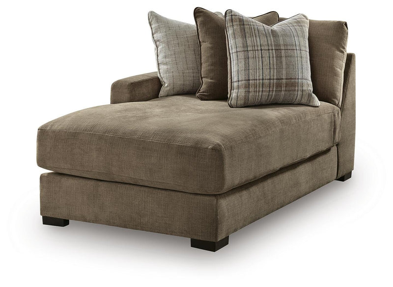 Ashley Furniture Camellia-Court double chaise sectional shown from an angled side view with plush cushions and a modern design.