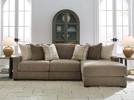 Ashley Furniture Camellia-Court sectional with chaise, featuring plush cushions and modern design in a neutral fabric.