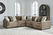 Ashley Furniture Camellia-Court sectional sofa with plush cushions and modern design, shown in a spacious living room setting.
