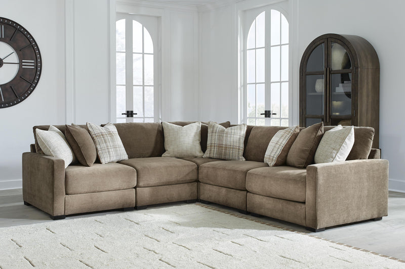 Ashley Furniture Camellia-Court sectional sofa with plush cushions and modern design, shown in a spacious living room setting.