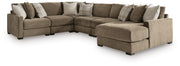 Ashley Furniture Camellia-Court sectional with chaise, featuring plush fabric upholstery and modern design in a cozy living room setting.