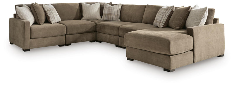 Ashley Furniture Camellia-Court sectional with chaise, featuring plush fabric upholstery and modern design in a cozy living room setting.