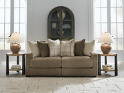 Ashley Furniture Camellia-Court sectional sofa with plush cushions and modern design, shown in a stylish living room setting.