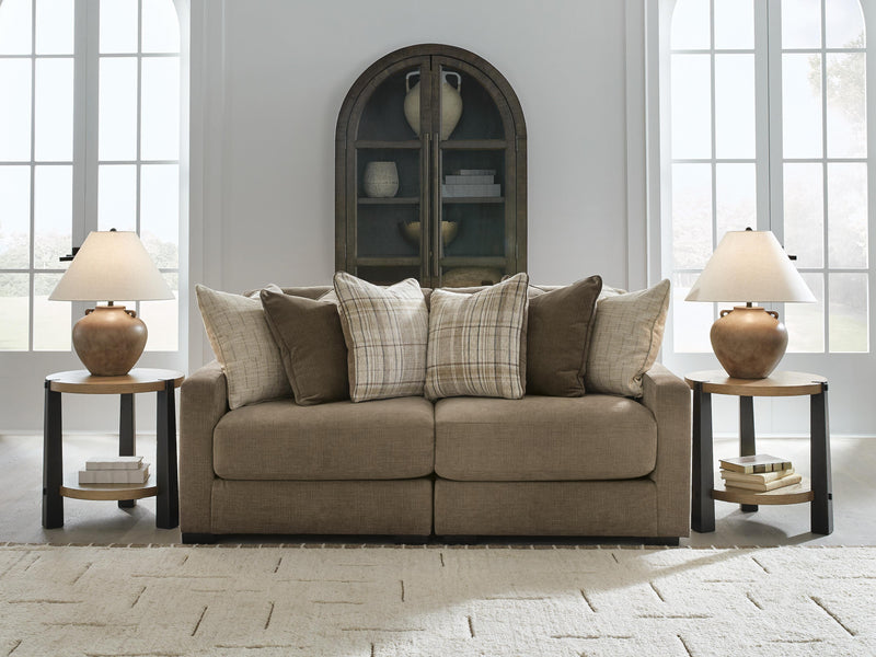 Ashley Furniture Camellia-Court sectional sofa with plush cushions and modern design, shown in a stylish living room setting.