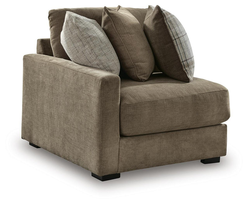 Ashley Furniture Camellia-Court sectional with chaise, showing a modern fabric sofa with plush cushions and a chaise lounge in an angled view.