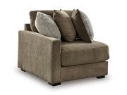 Ashley Furniture Camellia-Court sectional sofa shown from an angle, featuring plush cushions and a modern design in a spacious living room.