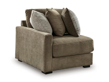 Ashley Furniture Camellia-Court sectional sofa shown from an angle, featuring plush cushions and a modern design in a spacious living room.