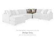 Ashley Furniture Camellia-Court sectional with chaise, tan fabric, plush cushions, and modern design, shown in a living room setting.