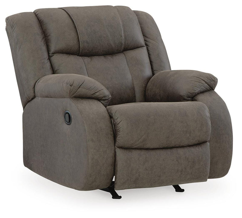 Ashley Furniture First Base Recliner, closed view showing plush fabric upholstery and padded armrests in a cozy living room setting.