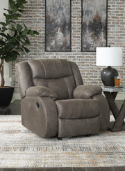Ashley Furniture First Base Recliner in dark fabric, featuring a plush backrest and cushioned armrests for comfortable seating.