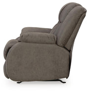 Ashley Furniture First Base recliner in brown leather upholstery, showing plush backrest and padded armrests.