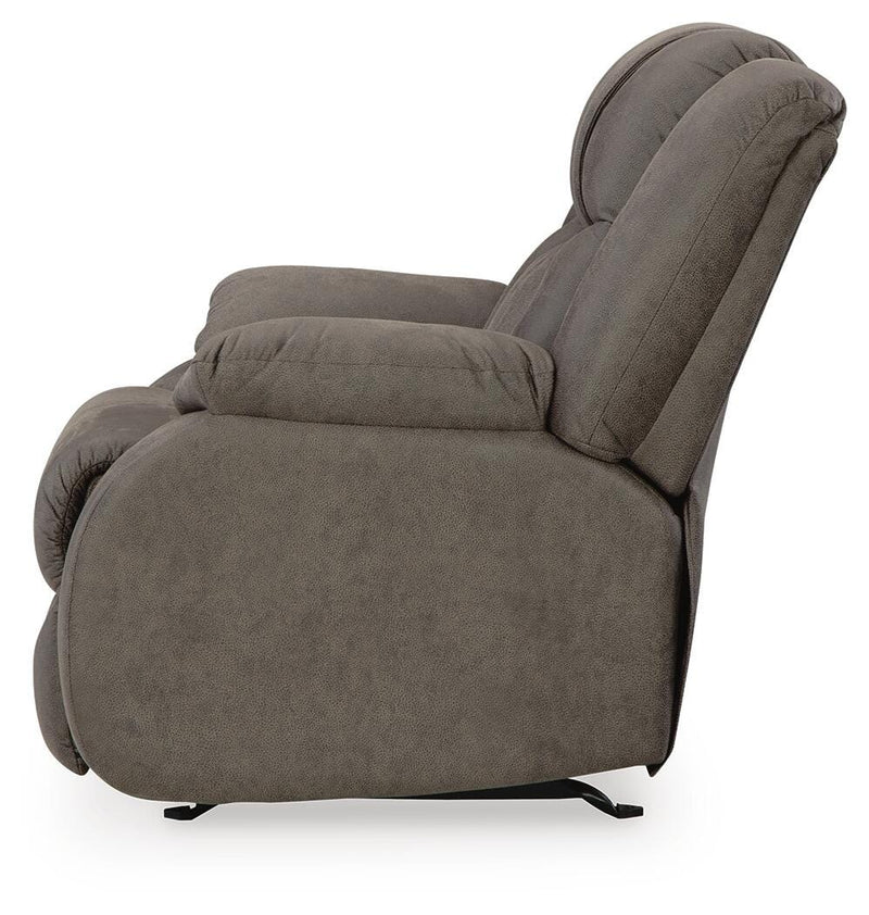 Ashley Furniture First Base recliner in brown leather upholstery, showing plush backrest and padded armrests.
