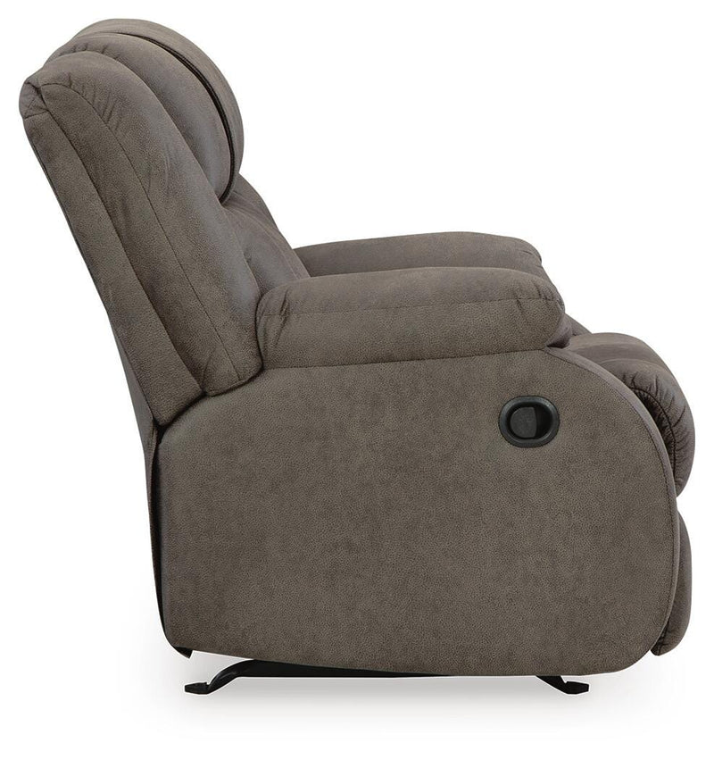 Ashley Furniture First Base Recliner in brown fabric with padded armrests and plush cushioning, shown from side view.