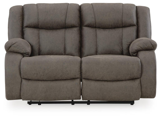 Ashley Furniture First Base reclining loveseat with plush cushions and a neutral fabric upholstery, shown from a front head-on view.