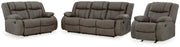 Ashley Furniture First Base living room set with sofa and armchair in a modern design, featuring neutral fabric upholstery and plush cushions.