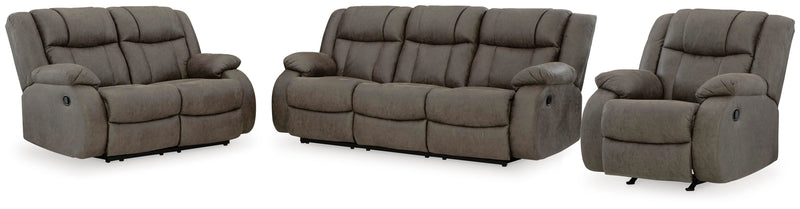 Ashley Furniture First Base living room set with sofa and armchair in a modern design, featuring neutral fabric upholstery and plush cushions.