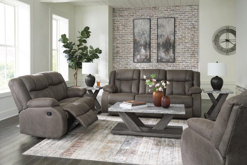 Ashley Furniture First Base living room set with sofa and loveseat in neutral fabric, arranged in a modern living room setting.