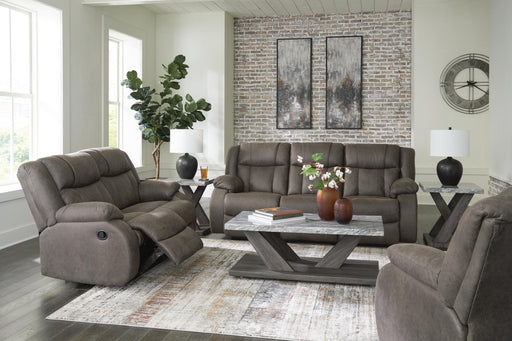 Ashley Furniture First Base living room set with sofa and loveseat in neutral fabric, arranged in a modern living room setting.