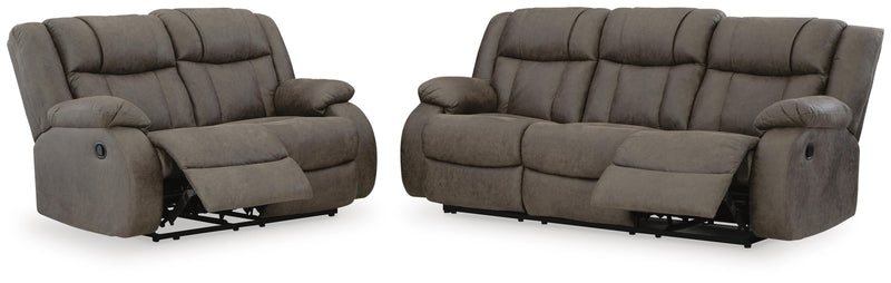 Open Ashley Furniture First Base living room set with sofa and loveseat, featuring neutral upholstery and modern design.