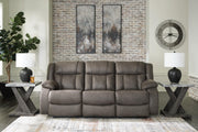 Ashley Furniture First Base reclining sofa with plush cushions and a modern design, shown in a closed position.