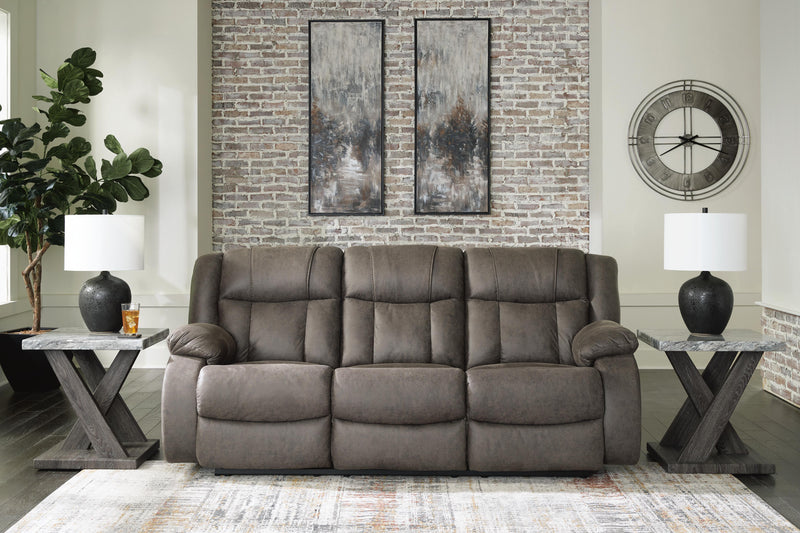 Ashley Furniture First Base reclining sofa with plush cushions and a modern design, shown in a closed position.