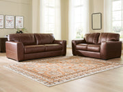 Ashley Furniture Brogliano living room set with plush sofa and matching armchair, featuring neutral upholstery and contemporary design.