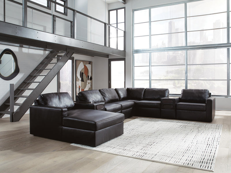 Ashley Furniture Modmax II sectional with chaise and built-in audio consoles, featuring plush cushions and modern design.