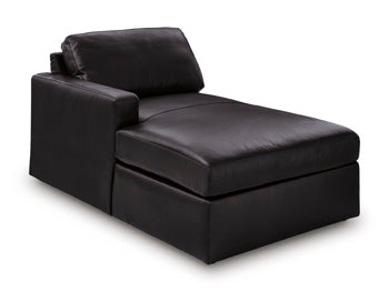 Ashley Furniture Modmax II sectional with chaise and integrated audio consoles, shown from an angled view in a modern living room setting.