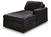 Ashley Furniture Modmax II sectional with chaise and storage consoles, shown from an angled side view in a modern living room setting.
