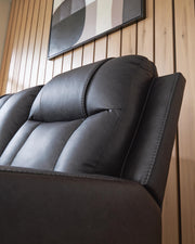 Ashley Furniture Mackmenville living room set featuring a sofa and armchair with neutral upholstery and decorative pillows.