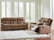 Ashley Furniture Mackmenville living room set with plush sofa, loveseat, and armchair in neutral fabric, arranged in a cozy living space.