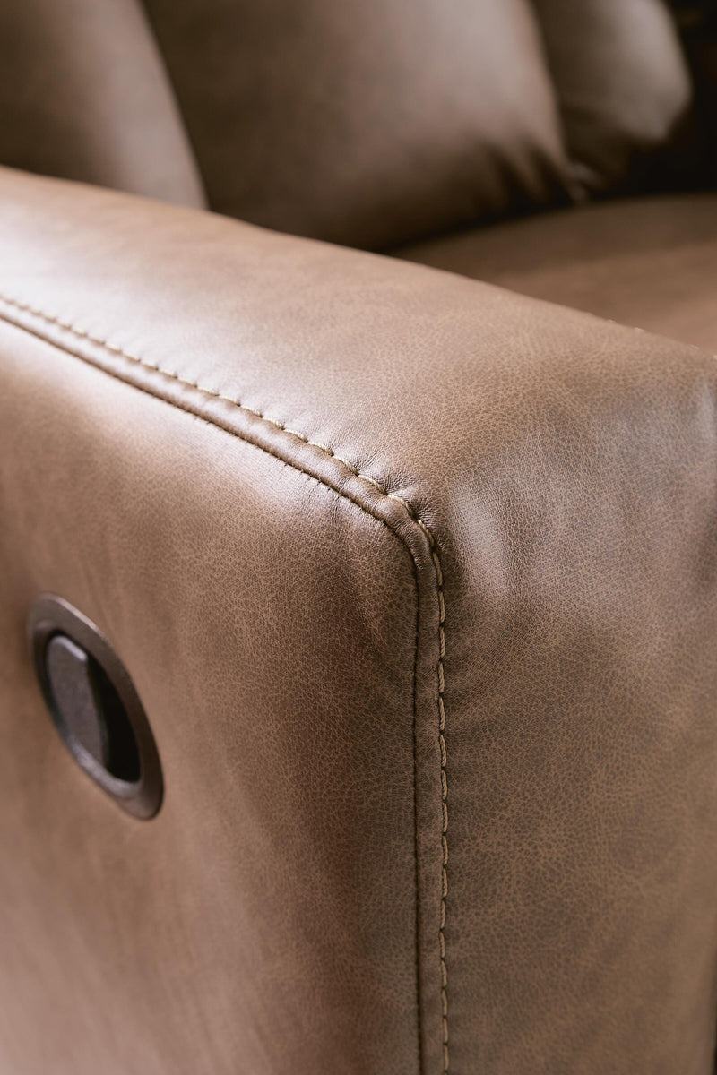 Ashley Furniture Mackmenville reclining sofa with plush cushions and stitched detailing, shown in a cozy living room setting.