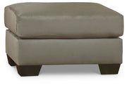 Ashley Furniture Darcy living room set with sofa and armchair in a modern design, shown in a cozy home setting.