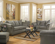 Ashley Furniture Darcy living room set with sofa and armchair, featuring plush cushions and neutral upholstery.