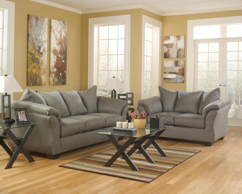 Ashley Furniture Darcy living room set with sofa, loveseat, and armchair in neutral fabric, arranged in a contemporary style.