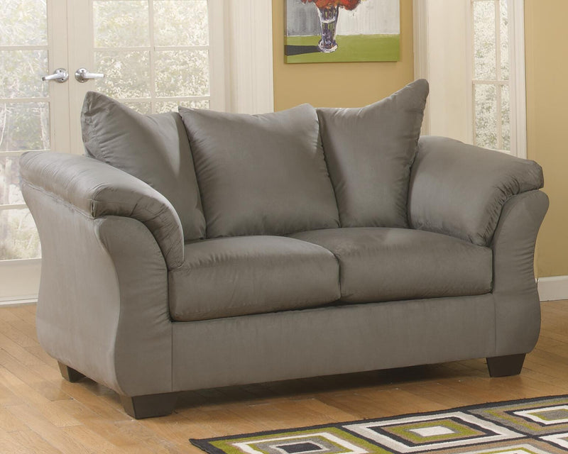 Ashley Furniture Darcy Loveseat with plush fabric, padded armrests, and stylish design, perfect for living room seating.
