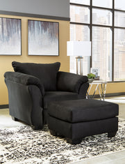 Ashley Furniture Darcy living room set with sofa and armchair in a modern design, featuring neutral upholstery and stylish cushions.