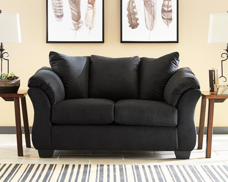 Ashley Furniture Darcy Loveseat with plush fabric and cushioned arms, shown in a cozy living room setting.