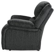 Ashley Furniture Draycoll recliner shown from the side, featuring plush cushioning and a contemporary design.