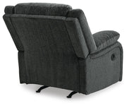 Ashley Furniture Draycoll recliner with plush upholstery and padded armrests, shown from the back in a cozy living room setting.