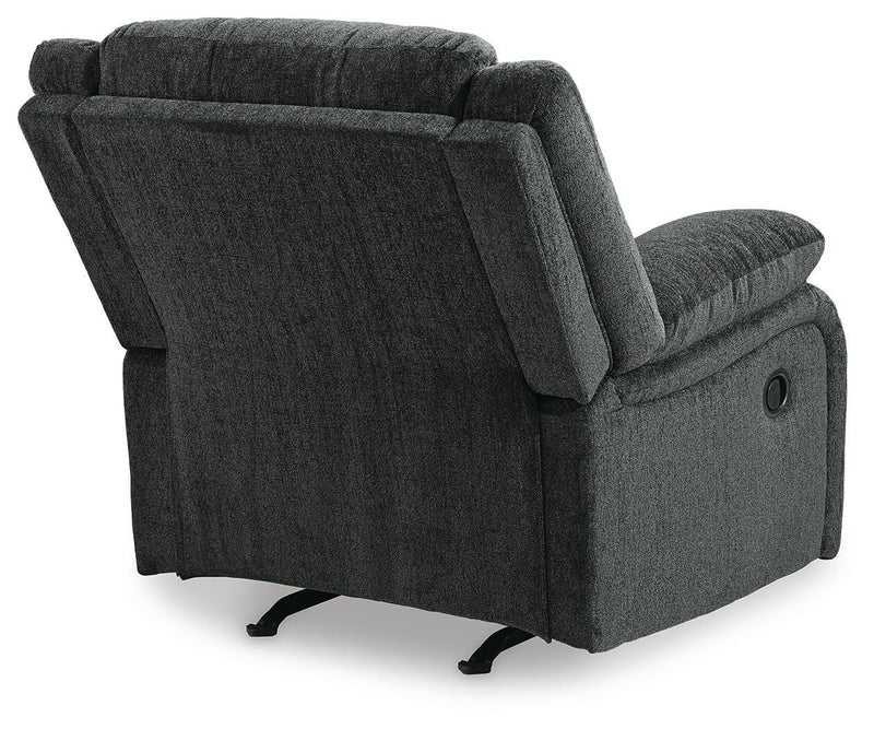Ashley Furniture Draycoll recliner with plush upholstery and padded armrests, shown from the back in a cozy living room setting.