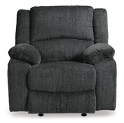 Ashley Furniture Draycoll power recliner with plush upholstery and padded armrests, shown in a head-on view.
