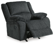 Open-angle view of Ashley Furniture Draycoll recliner with plush cushioning and dark brown leather upholstery.