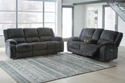 Ashley Furniture Draycoll living room set with sofa and armchair, featuring plush cushions and neutral fabric upholstery.