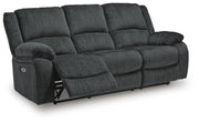 Ashley Furniture Draycoll power reclining sofa shown in an open angle, featuring plush cushions and a modern design.